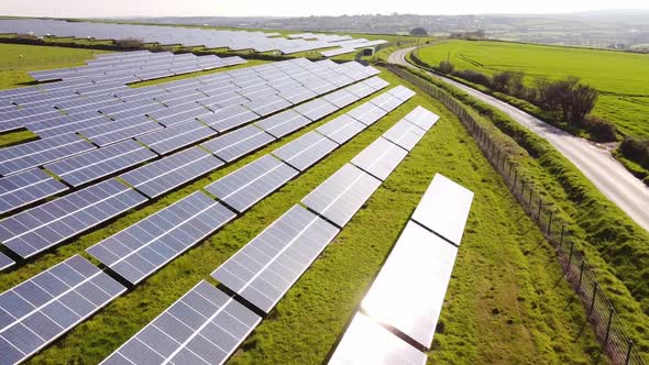 Flying over solar farm panels in British countryside