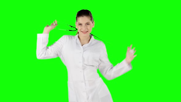 Female Doctor Dancing with Stethoscope. Green Screen