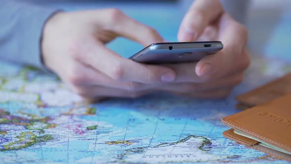 Man Using Travel App on Smartphone, Buying Tour and Booking Tickets Online