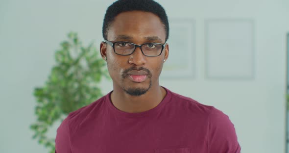 Handsome Guy with Glasses Looking Into Focus of Camera