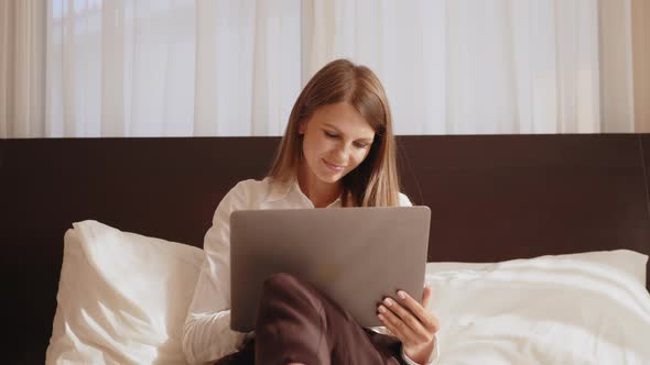 Thoughtful Concerned Woman Working on Laptop Computer Looking Away Thinking