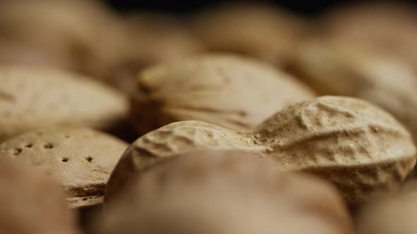 Cinematic, rotating shot of a variety of nuts on a white surface - NUTS MIXED 