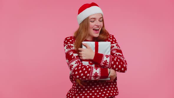 Cheerful Girl in Christmas Santa Sweater Getting Present Gift Box Expressing Amazement Happiness