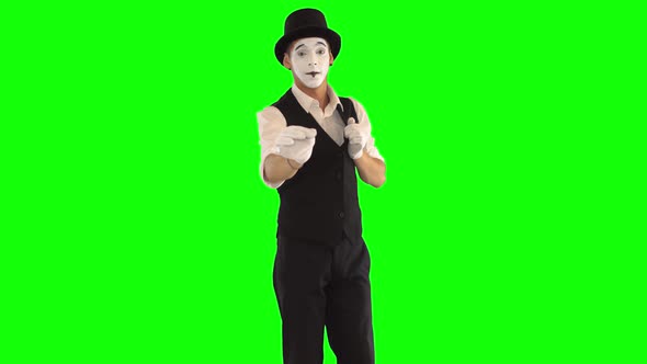 Funny Male Mime with White Face in White and Black Clothes Doing Performance