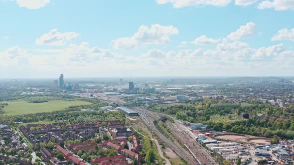 Slow drone shot over railway running through Kensal Willesden and north acton