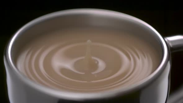 Coffee drop making ripple in cup, Slow Motion