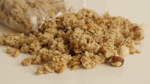 Slow tilt on healthy muesli with  hazelnuts 4K 2160p 30fps UltraHD footage - Pile of crunchy cereals