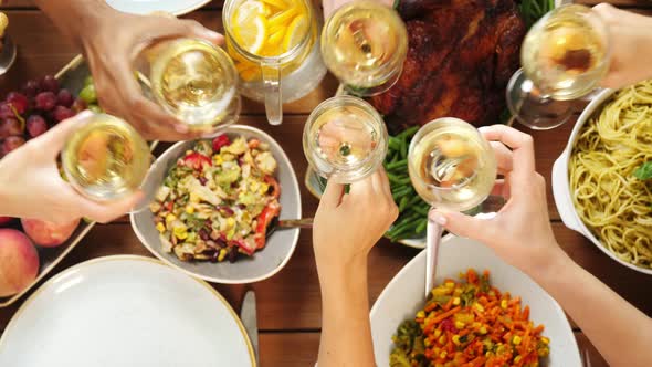 Group of People Eating and Drinking Wine at Table