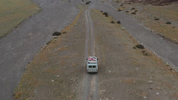 Offroad Vehicle Goes on a Dirt Road Among the Mountains
