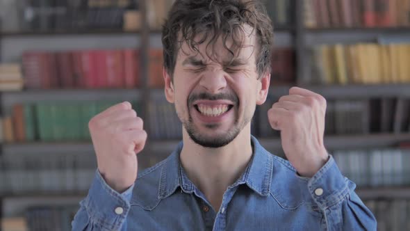 Casual Young Man Upset By Loss While Working in Office