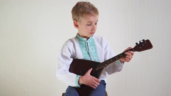 Russian Boy National Dress Plays Balalaika