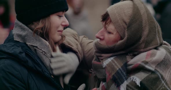 Mature Homeless Woman Consoling Distraught Daughter