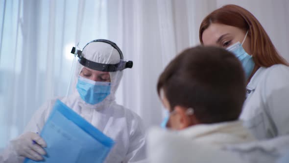 Female Doctor in Protective Suit with Helmet and Medical Mask To Protect Against Deadly Infection