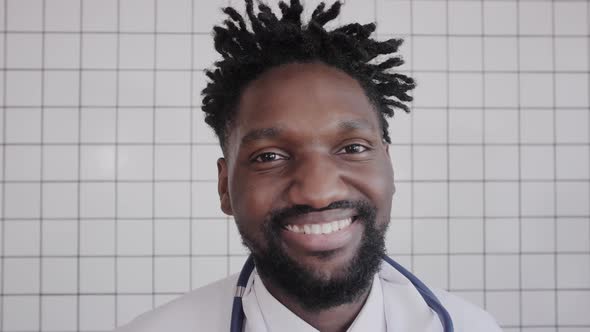 Closeup Portrait of Black Doctor Smiling and Looking at Camera