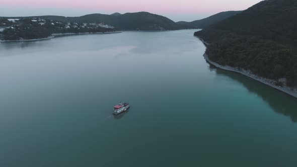 Flight Over the Lake and Over the Ferry to the Abrau Durso Under the Anapa Winery Sunset Day