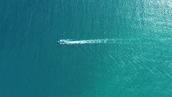 Aerial view of Long Tail Boats floating on crystal water along the sand beach in Thailand.Summer Aer