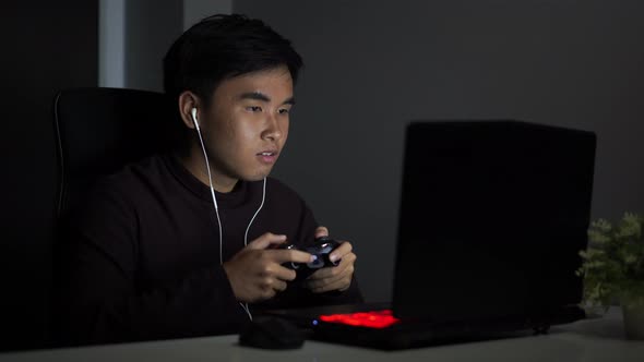 young man using joystick to playing games