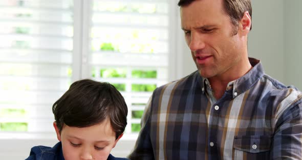 Father helping son with school homework