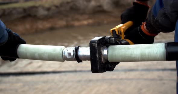 Workers are Tightening the Connection of the Cables Before Laying Them