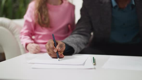 AfricanAmerican Man Draws Picture Teaching Girl English