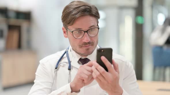 Portrait of Male Doctor Using Smartphone