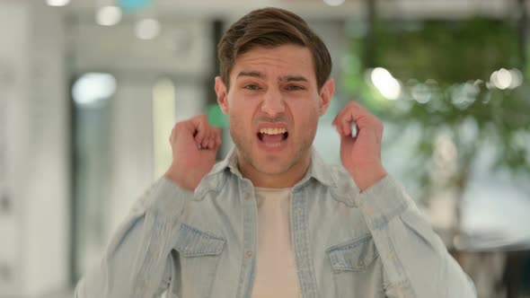 Portrait of Angry Creative Young Man Shouting Screaming