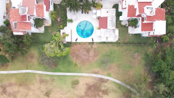 Top drone shot of swimming pool, hotel, houses in Cancun, Mexico.