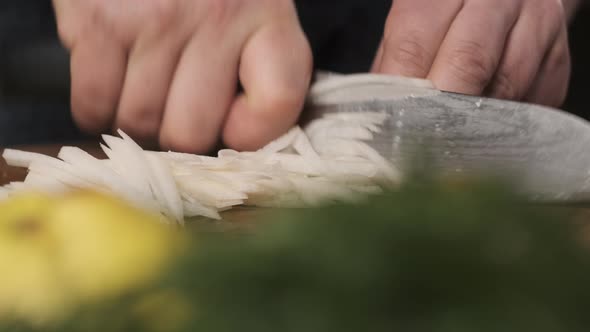 Chef Cuts Daikon Radish Cut Into Strips on Cutting Board