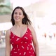 Smiling Woman in Trendy Dress Walking on Street and Looking at Camera - VideoHive Item for Sale