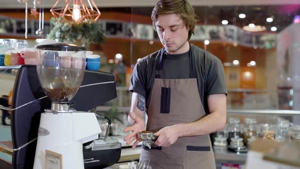Male Barista Is Cooking Coffee in a Cafeteria
