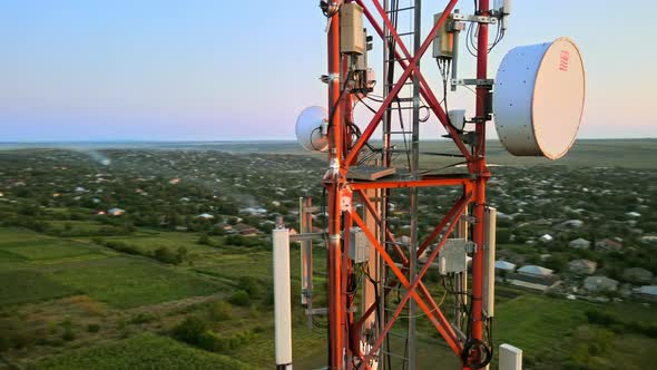 Aerial drone view of a communication tower, located near a village in Moldova. Sunset