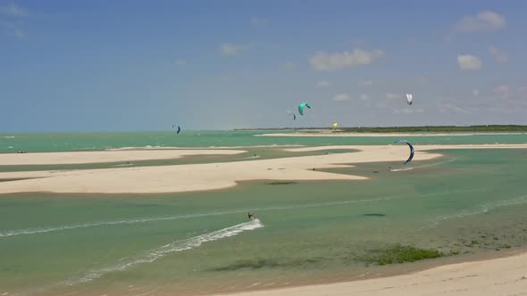 Brazilian kite surfer in high speed jumping with several kites in background