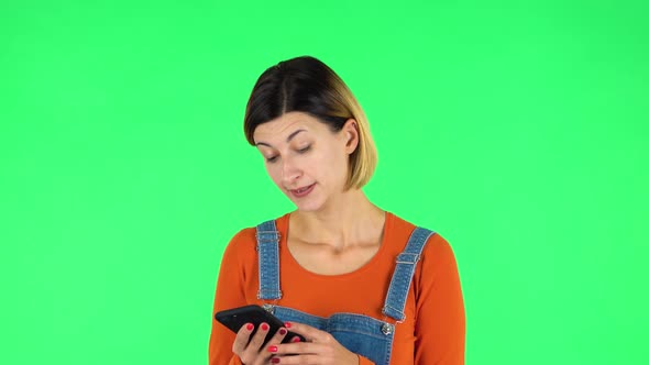 Girl Angrily Texting on Her Phone. Green Screen