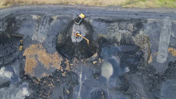 Aerial View on Top Excavator Loads the Car with Coal