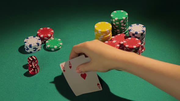 Poker Player Showing Pair of Aces, Good Chance to Win Big Bank From Rivals