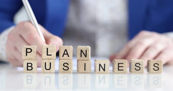 Wooden Business Plan Cubes on the Boss's Desk