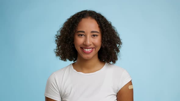 Vaccinated African Lady With Plaster On Hand Posing Blue Background