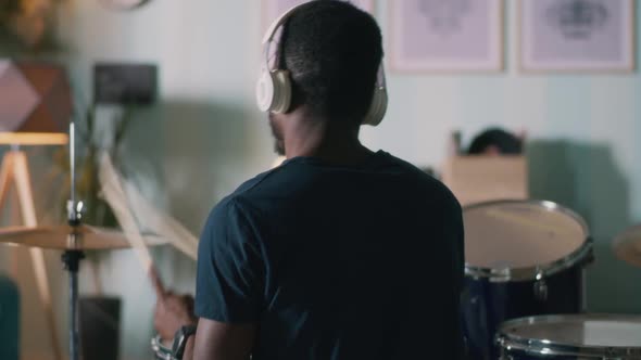 Black Man Playing Drums at Home