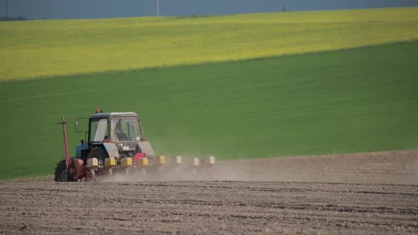 Tractor Plowing Field In Spring Season. Beginning Of Agricultural Season