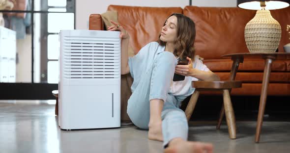 Woman with Air Purifier or Conditioner at Home