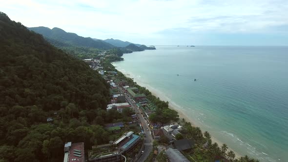 Aerial view of small coastal city surrounding by tropical forest, Thailand.