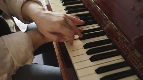 Woman Playing on Vintage Wooden Piano