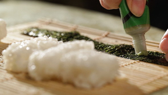Putting Wasabi On Nori Sushi