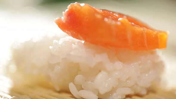 Putting Piece Of Salmon On Sushi Rice 