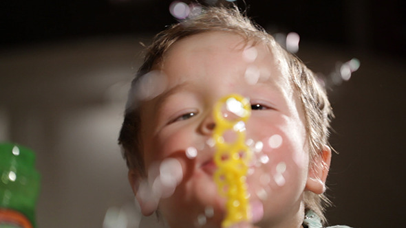 Two Year Old Boy Blowing Soap Bubbles 