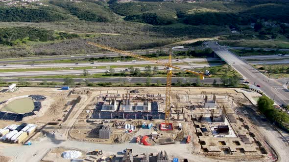 Aerial View of New Construction Site with Crane and Building Materials. 