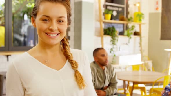 Portrait of beautiful waitress holding salad in plate 4k