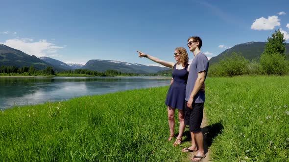 Couple pointing out at distance 4k