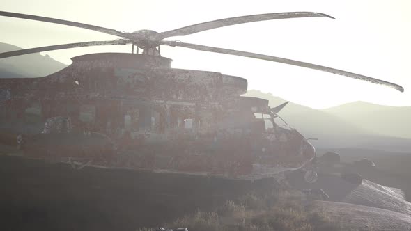 Old Rusted Military Helicopter in the Desert at Sunset alt