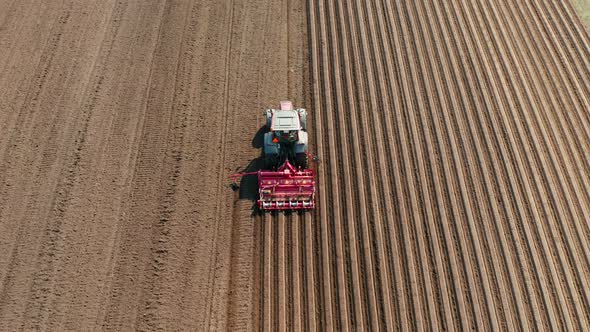 Tractor with Disc Harrows on the Farmland